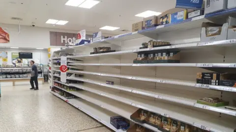 Ian Vince Empty pasta shelves at the Tesco store in Royston, Hertfordshire