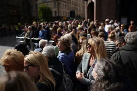 Ian Forsyth/Getty Images People await the King