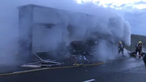 Cambs Fire and Rescue Lorry fire being tackled by firefighters on A14 at Brampton