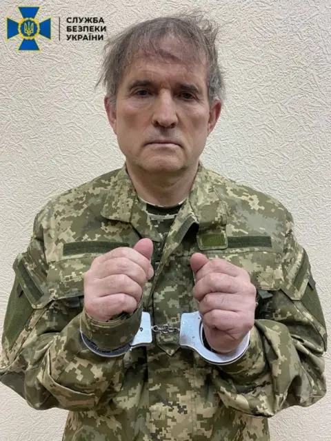 SBU via Reuters Handout photo by Ukraine's security service SBU purportedly showing Viktor Medvedchuk in handcuffs