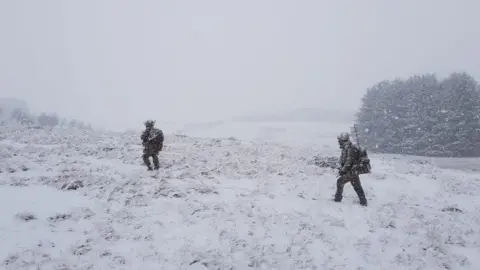 Tom Ferguson/MoD Crown Soldiers walking through the snow in the Brecon Beacons