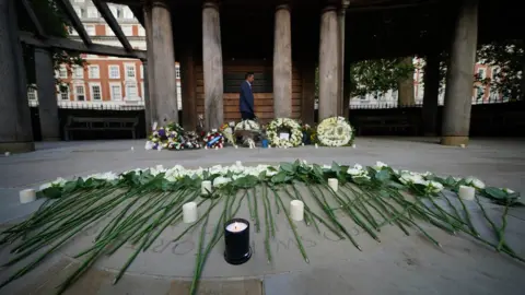 Yui Mok/PA Media Candles in the September 11 Memorial Garden in Grosvenor Square