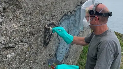Andrew Carr Grafitti cleaning at Rame Head Chapel