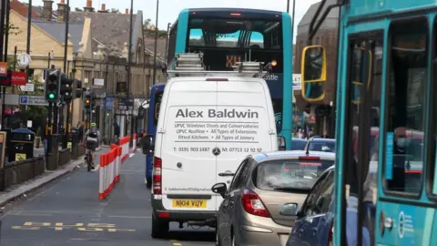 BBC Traffic on Gosforth High Street, passing the row of bollards