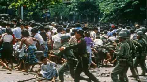 Science Photo Library Protesters and military in a Yangon street in 1988