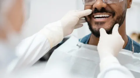 Getty Images Man seeing dentist