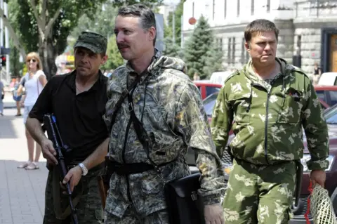 AFP Igor Girkin, aka Strelok (C), walks with his bodyguards in the eastern Ukrainian city of Donetsk on 11 July 2014