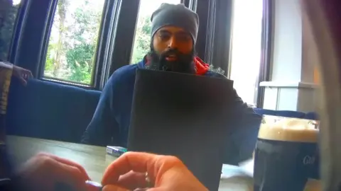 Himesh Shingadia, who set up a Reddit forum which shared women's private images, pictured at a meeting with an undercover reporter