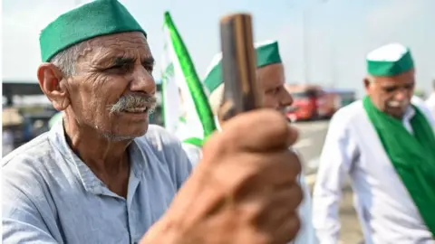 Getty Images Farmers gather at the protest venue in Gazipur Delhi-Uttar Pradesh border during a nationwide strike called by the farmers as they continue to protest against the central government's agricultural reforms in Ghaziabad on September 27, 2021.