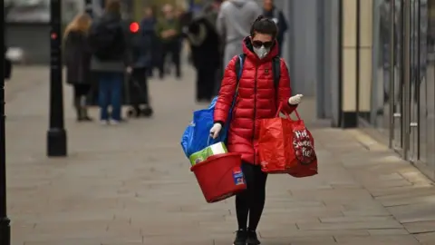 Getty Images lone shopper wearing a mask