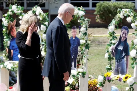 Reuters U.S. President Joe Biden and first lady Jill Biden pay their respects at the Robb Elementary School memorial