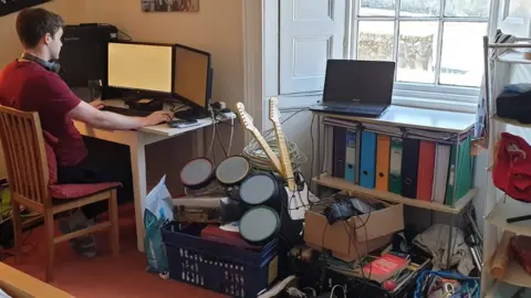 Laura Jon working in his childhood bedroom