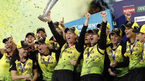 Australia captain Meg Lanning lifts the Women's T20 Cricket World Cup trophy and celebrates with team mates after winning the final against India at the Melbourne Cricket Ground in March 2020