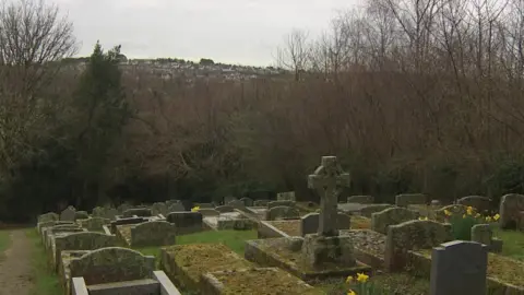 Tina's home can be seen from the graveyard