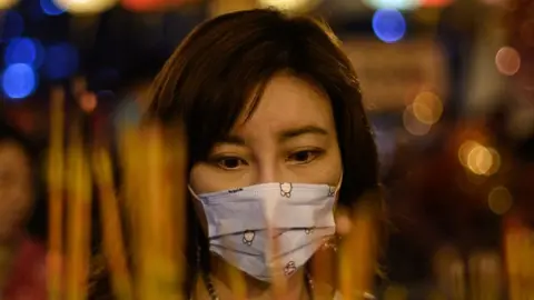 AFP Woman wearing face mask