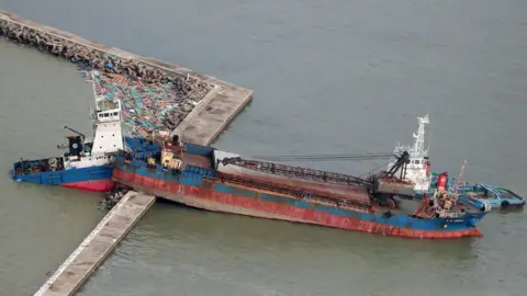 AFP An aerial view from a Jiji Press helicopter shows a ship wedged on a breakwater in Hyogo prefecture