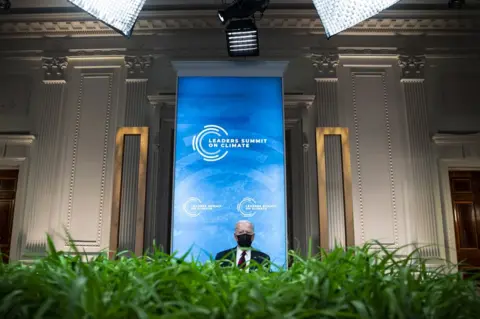 Al Drago / EPA President Joe Biden wears a face mask whilst attending the virtual Leaders Summit on Climate in the White House, Washington