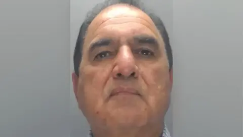 Muhammad Iqbal, a man in his 60s with thin, black hair.