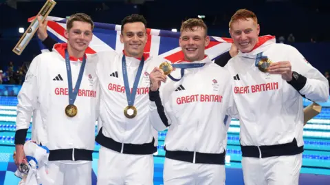 Great Britain's Duncan Scott, James Guy, Matthew Richards and Tom Dean pose with their gold medals