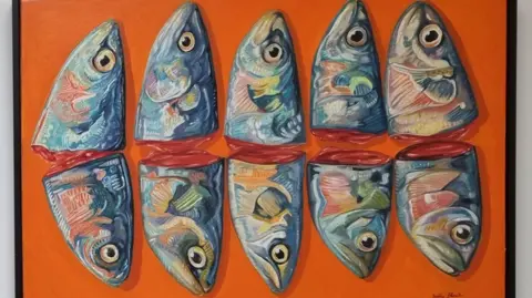 SALLY BLACK A painting of 10 colourful severed fish heads on an orange background.