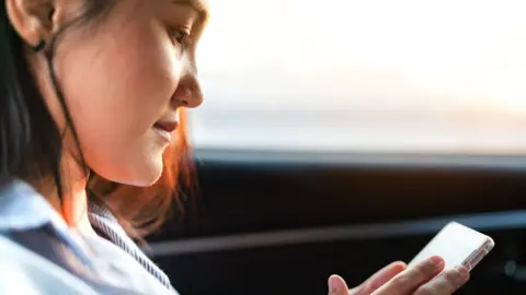 Getty Images woman on mobile