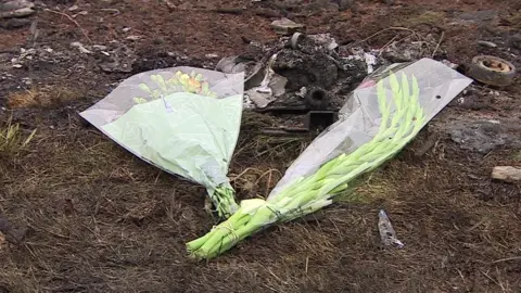 Flowers have been left at the crash site