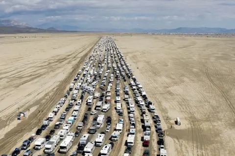 Matt Mills McKnight / Reuters Vehicles are seen departing the Burning Man festival in Black Rock City, Nevada, US