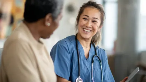Getty Images Nurse with woman