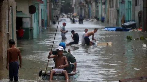 AFP/Getty Cubans wade through a flooded street in Havana, on September 10, 2017.