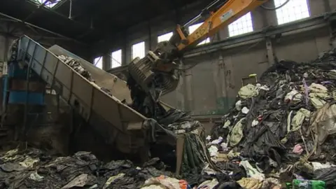 A crane sorting through rubbish