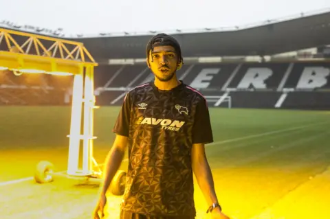 Martyn Ewoma Eyez in a football ground