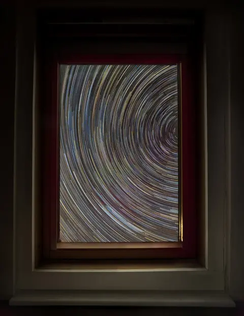 Andrew Fusek Peters / SWNS Star trail taken from inside a house in Shropshire