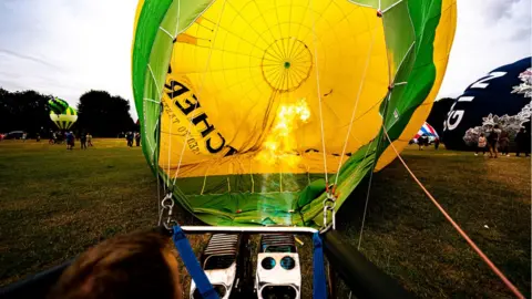 PA Media A hot air balloon preparing to take flight