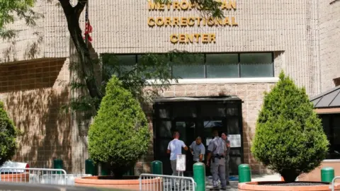 Reuters Workers outside the jail