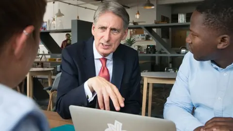 Getty Images Philip Hammond talks to entrepreneurs