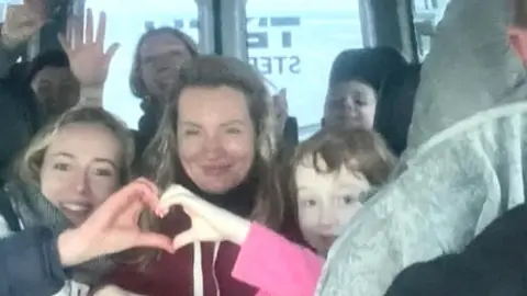 Family photo Ukrainian refugees in minibus