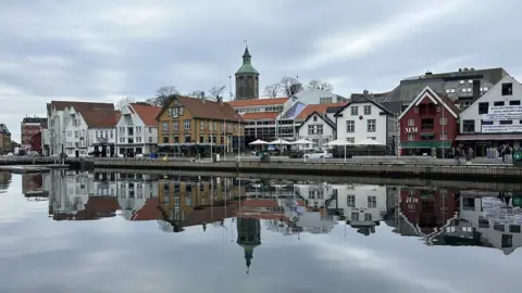 BBC A line of buildings reflected in water