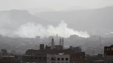 Reuters Smoke rises from Sanaa, Yemen, during fighting between Houthi rebels and supporters of Ali Abdullah Saleh (4 December 2017)