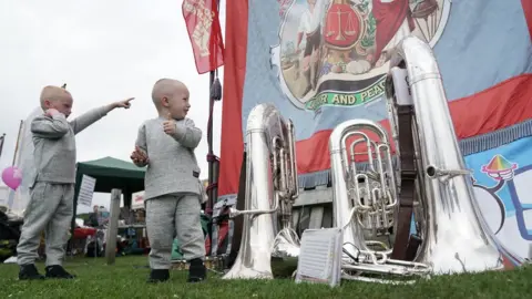 PA Media Two boys look at a banner during the Durham Miners" Gala.