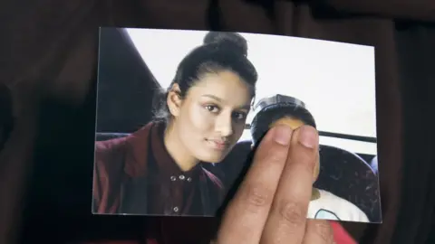 Press Association Shamima Begum's sister holds a photo of Shamima Begum in 2015