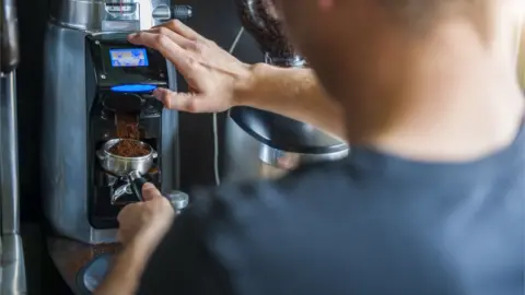 Getty Images A barista makes a coffee