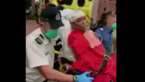 Reuters Mobile phone footage showed Mr Sham being taken to hospital from an ambulance