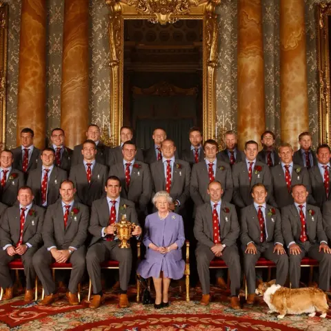 PA Media Queen Elizabeth II, and Berry the corgi, with the England rugby squad, at a reception at Buckingham Palace in London to celebrate winning the Rugby World Cup.