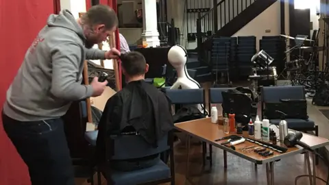 Big Brunch Barber Lewis Prime cutting hair during the Big Brunch 2019