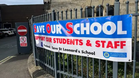 PA Media A Save Our School sign put up during a parents' demonstration over Raac outside St Leonard's Catholic School in Durham