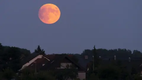 EPA/RONALD WITTEK Lunar eclipse on 16 July 2019 viewed from Speyer, Germany