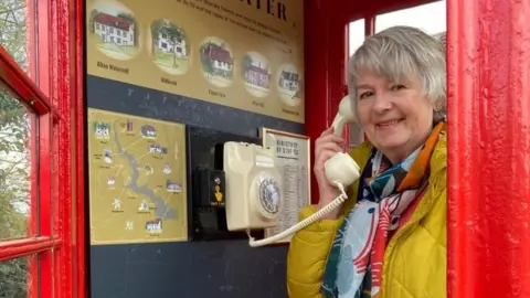 Jane Kirk in the phone box