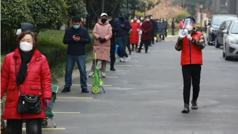 Getty Images Xi'an residents lining up to get Covid tested