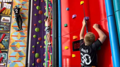 Andrew Turner/BBC Children using the climbing walls at the Marina Centre in Great Yarmouth