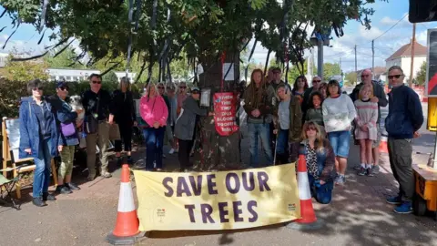 Save the Holt Farm Oak Tree Resident campaigners at the Holt Farm oak tree in Rochford